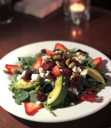 Fresh salad with avocado, strawberry, beets and goat cheese