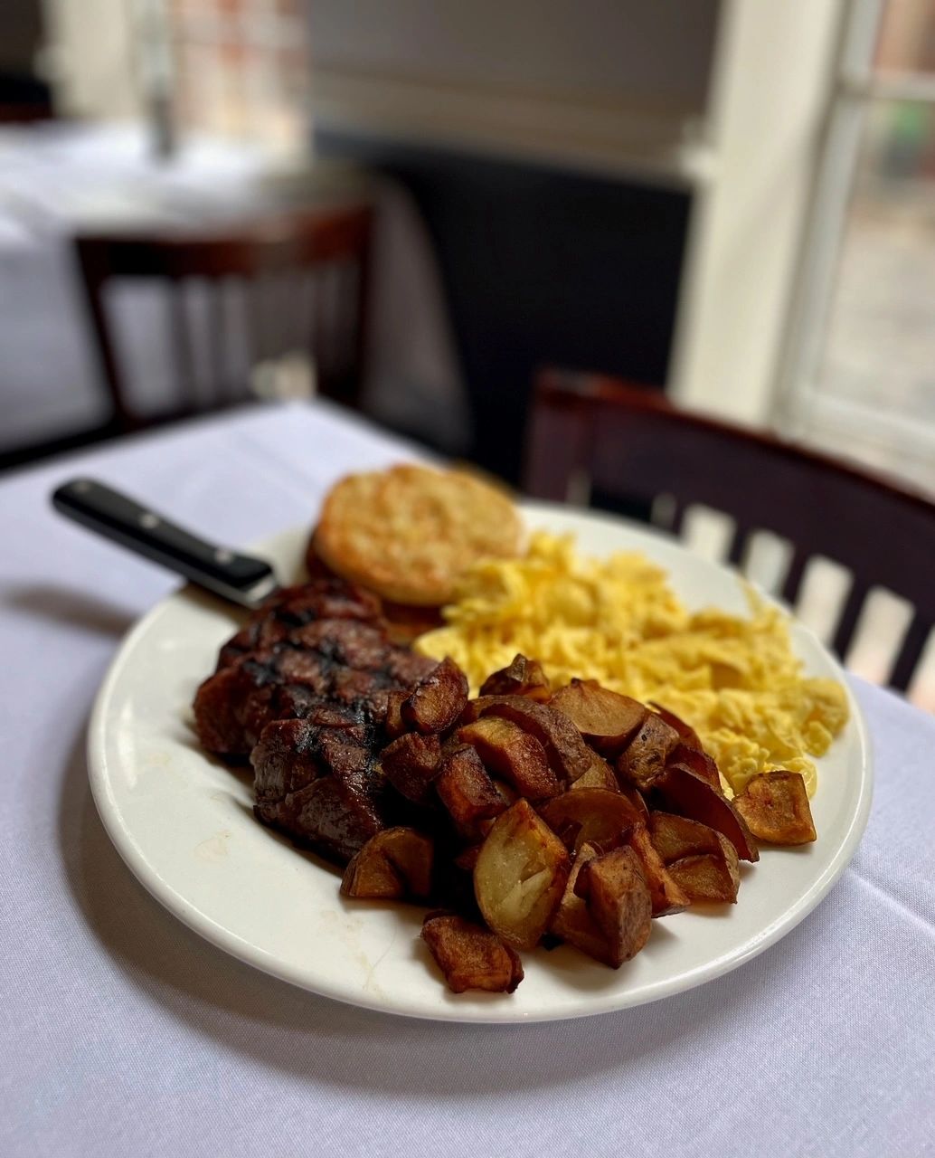 Grilled steak with potato wedges and fries